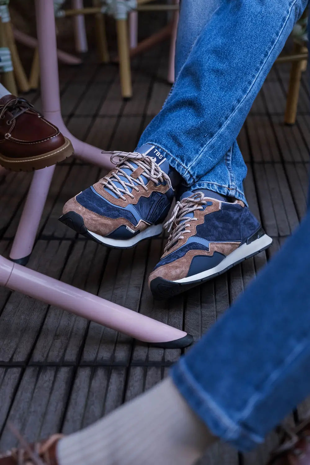 Baskets retro running en cuir velours marine et marron TBS HOMME Dinboat portées en terrasse avec un jean