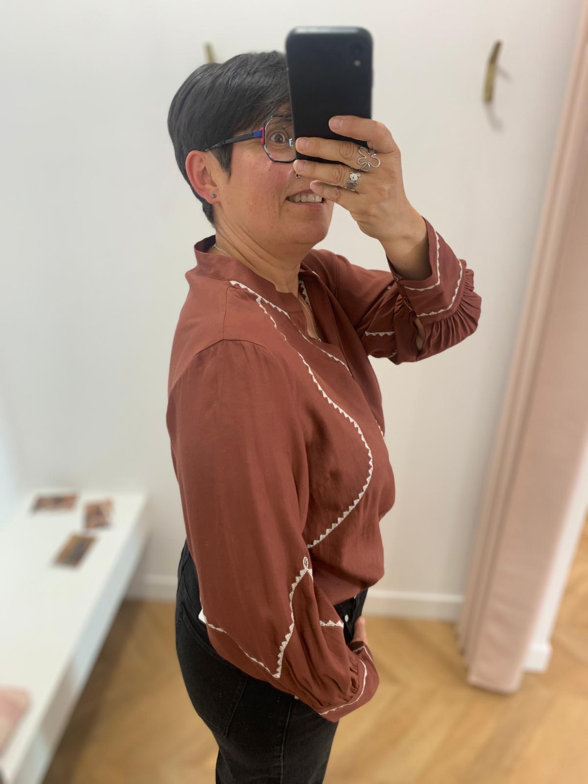 Vue de profil de la blouse Viramette bordeaux VILA mettant en valeur les broderies des manches