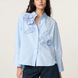 Plan moyen de la blouse bleu clair Iced Blue à fleurs 3D FABIENNE CHAPOT portée avec un jean
