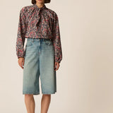 Silhouette complète modèle portant la blouse ample Liberty Rainbow Taya DES PETITS HAUTS et des babies noires