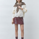 Look casual chic avec le gilet blanc cassé Gaiari SUNCOO FEMME, jupe en cuir bordeaux et pull marron sur les épaules