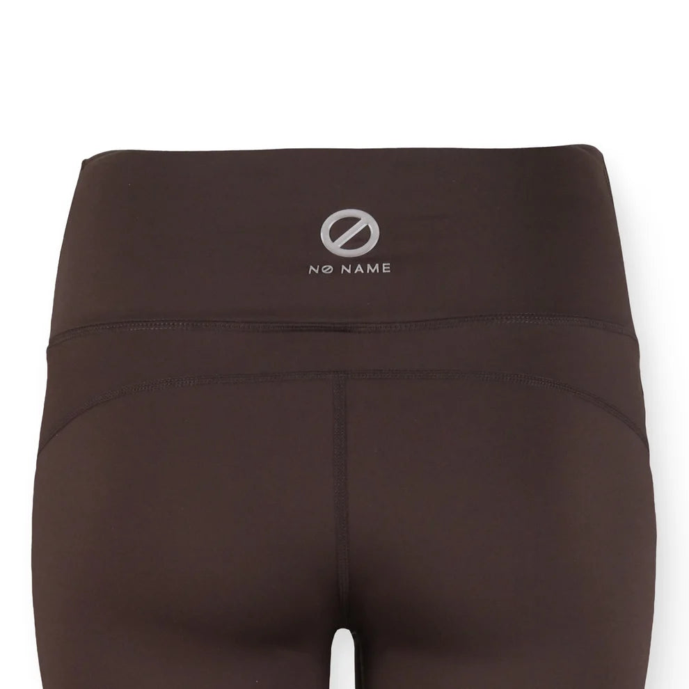 Gros plan sur la ceinture haute au dos et le logo argenté réfléchissant du legging NO NAME Carter