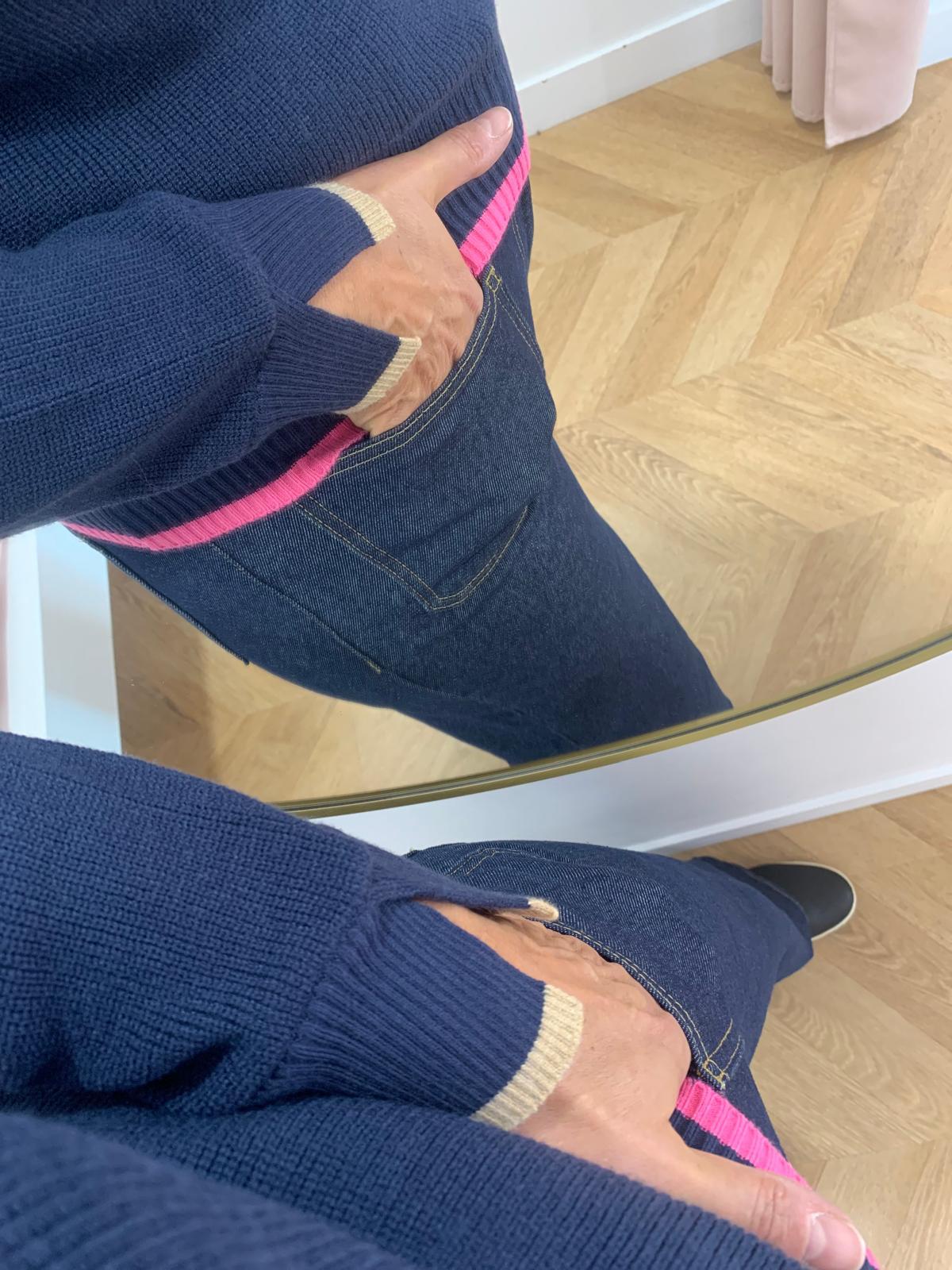 Gros plan sur la fente des poignets avec liseré beige et le bord-côte rose du pull PU620