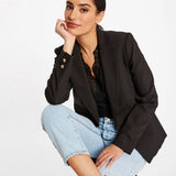 Veste de tailleur noire MORGAN Vlime avec bouton doré portée de face avec un caraco dentelle et un jean