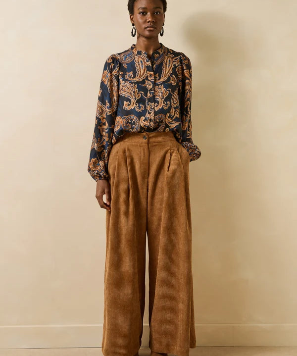 Vue en pied du mannequin portant la blouse fluide Getanoa bleu encre et pantalon large marron
