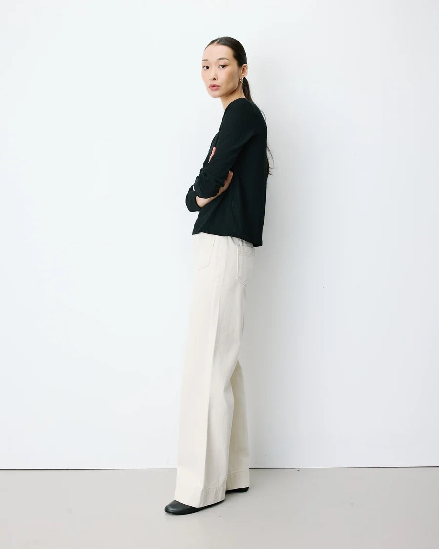 T-shirt ABRICOT GRACE & MILA noir – porté de profil avec pantalon large blanc